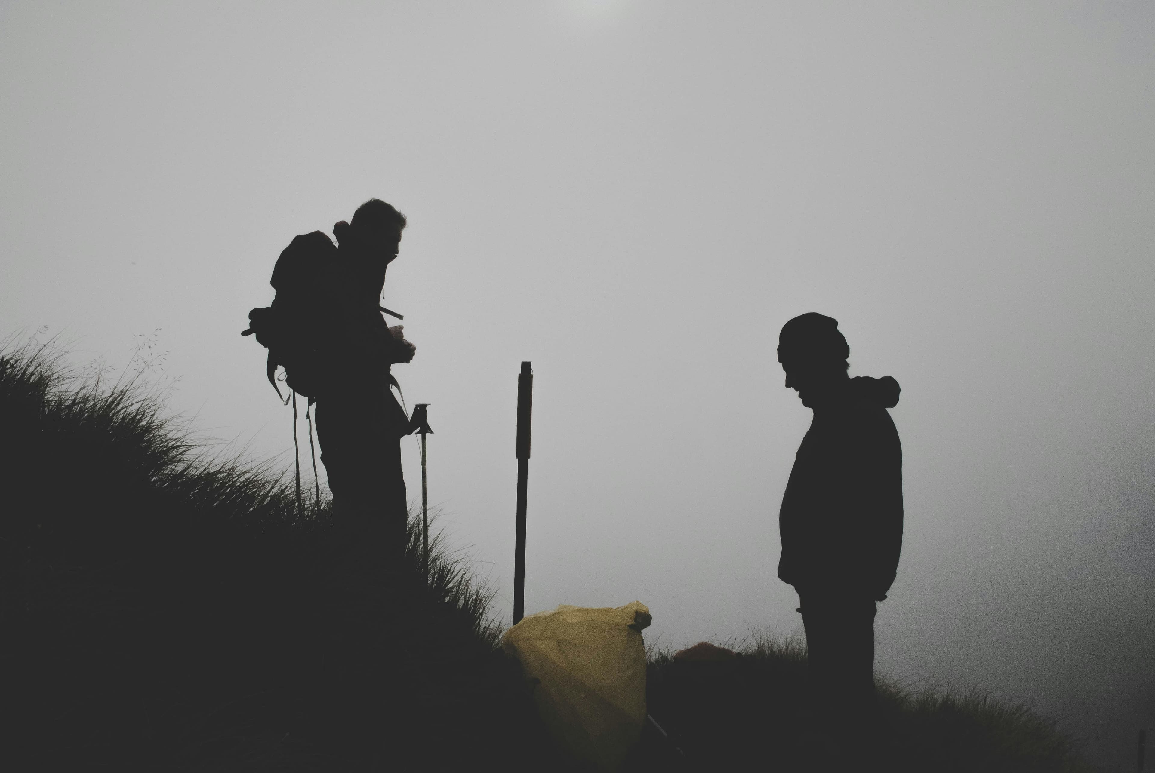 Silhouette of mountain climbers at sunset